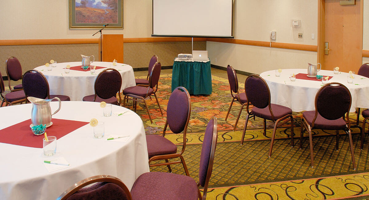 Meeting room set up for speakers and visual presentation at the Holiday Inn North Vancouver