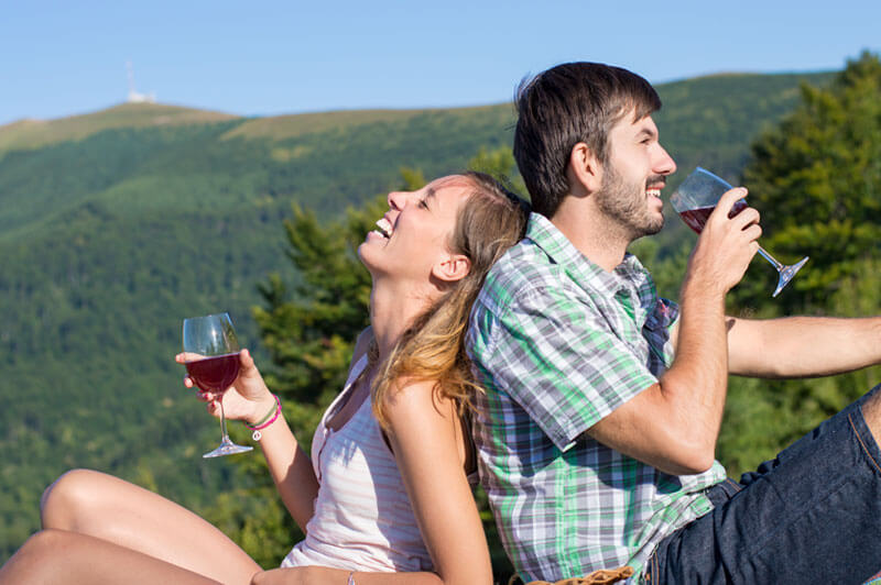 Two people enjoying wine and a romantic getaway among the mountains in North Vancouver